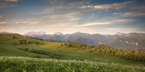 Green field on a background mountains (Eastern and Western Aches