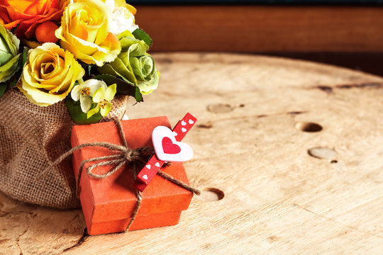 Gifts and bouquets on wooden.
