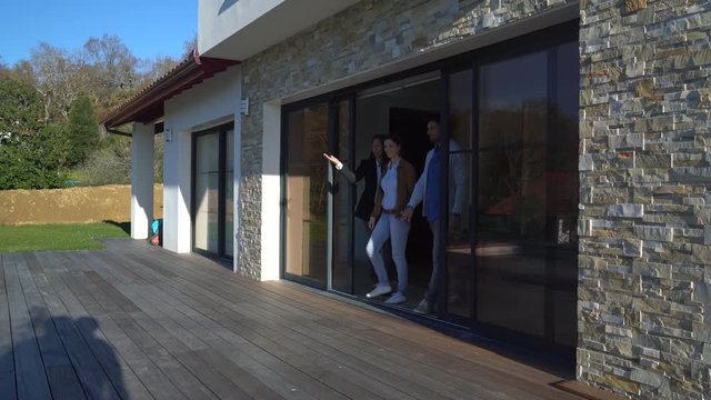 Couple with real-estate agent visiting house for sale