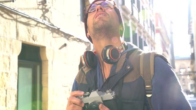 Hipster guy taking pictures in european city