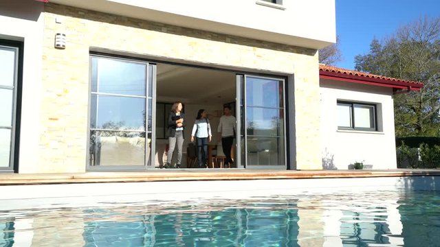 Couple with real-estate agent visiting house for sale