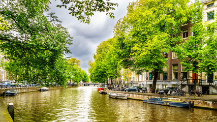 Typical Canal Scene with Historic Houses dating back to the Middle Ages along the canals in Amsterdam