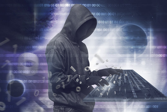 Hooded hacker man with vendetta mask typing on virtual keyboard
