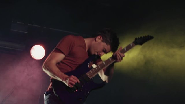 Rock n' Roll Electric Guitarist Jumping in Slow Motion