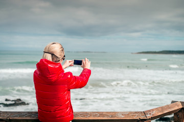 Woman taking pictures with mobile phone