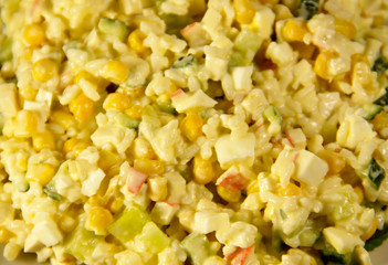 Salad with crab sticks corn cucumber eggs and rice