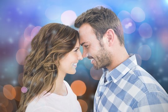 Composite image of happy young couple rubbing nose