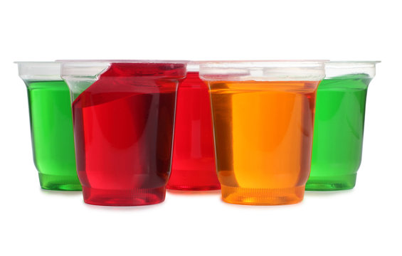 Jam in plastic with raw fruit on white background