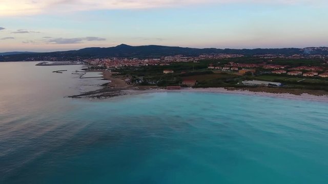 Aerial shot, incredibly beautiful calm sea in the sunset light with lots of clouds, filmed with drone