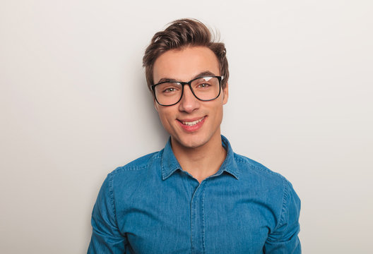 closeup picture of a young man with glasses smiling