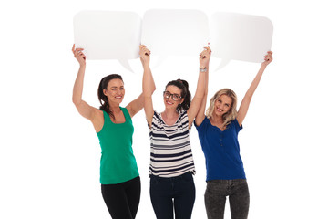 three happy women holding blank speech bubbles over their heads