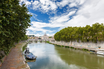 Fototapeta na wymiar Cloudy view at Tiber and Basilica di San Pietro with bridge in Vatican, Rome, Lazio region, Italy.