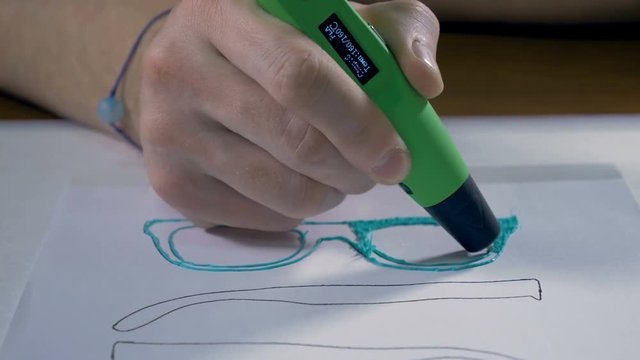 Hands drawing with 3D printing pen, producing real modern glasses. 4K.