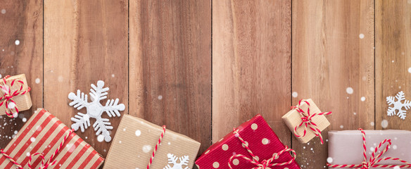 Gift boxes and Christmas ornaments on wood background