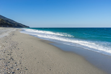 Fototapeta na wymiar View on Mediterranean Sea with sunny sand beach. Chorefto village, Pelion, Greece. 