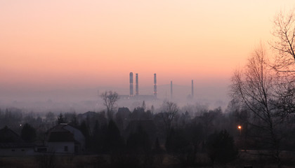 Industrial landscape in the mist at sunset