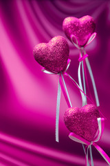 Valentines day. Pink hearts on pink blurred background closeup with copy space for congratulation 