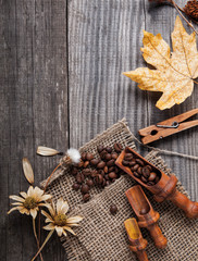 dry plants and fruit still life on a wooden table, view from the top of the dried berries of coffee on vintage board