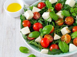 Vegetarian salad with cherry tomato, mozzarella and rucola