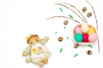 quail eggs, Easter Bunny, willow branches and colorful eggs in basket on white background.