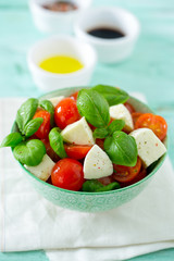 caprese salad on turquoise background