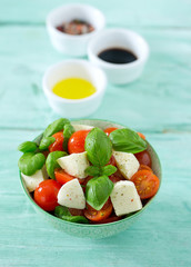 caprese salad on turquoise background