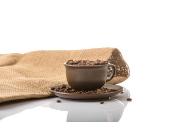 Coffee cup with roasted coffee beans.