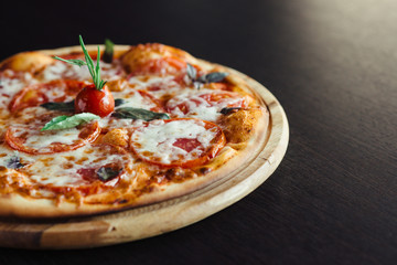 Italian Pizza on the Board in the dark table