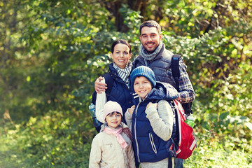 happy family with backpacks hiking