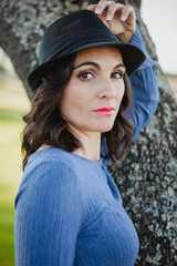 Stylish young woman with black hat