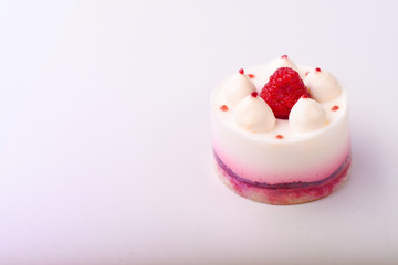 Obraz na płótnie Canvas Delicious cake with raspberries on a white background