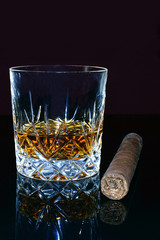 Glass of whiskey and a cigar.