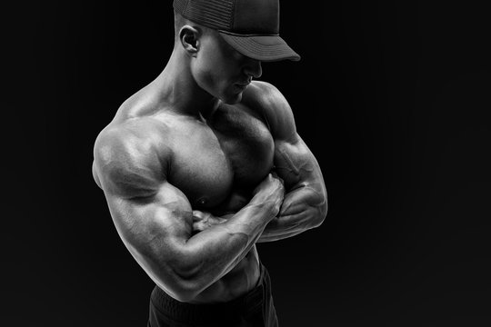 Shot of healthy muscular young man with black beseball cap