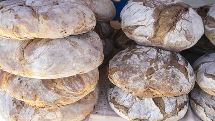 Table with loaves of bread made by hand at a medieval fair in sp
