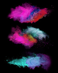 Fototapeta na wymiar Explosion of colored powders on black background