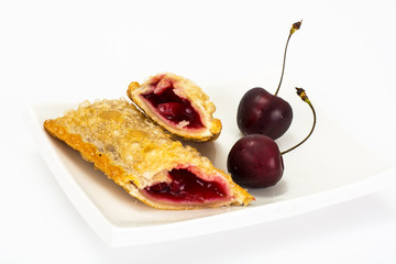 Puff pastry with fresh cherries on a white