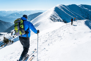 Skialpinists group in european alps, skialpinists on snowy mountains, dangerous mountain,...
