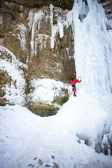 The climber climbs on ice.