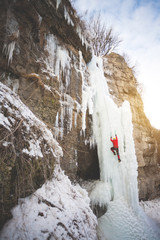 The climber climbs on ice.