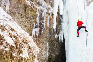 The climber climbs on ice.