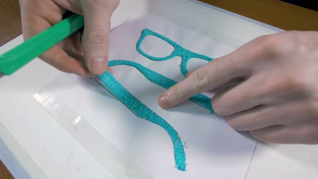 Man assembling glasses made with 3D pen. Innovative production technology. 4K.