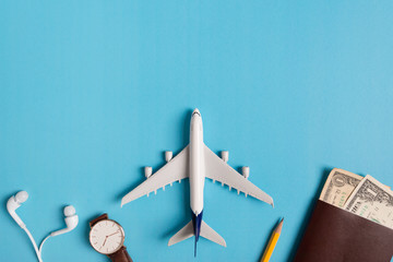 Preparation for Traveling concept, watch, airplane, money, passport, pencils, book, on blue...