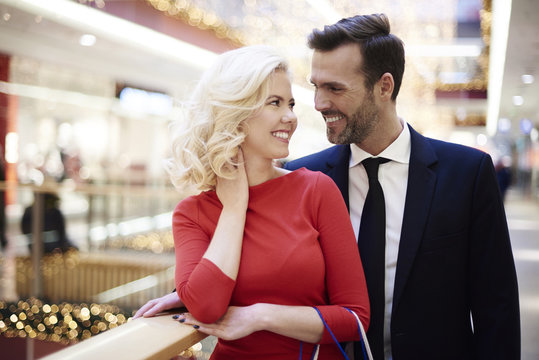 Cheerful couple over shopping in the mall