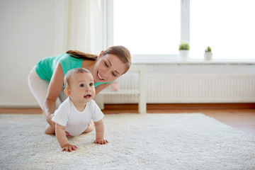 happy mother playing with baby at home