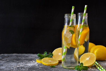 Summer drink - cold lemonade with mint on a concrete background