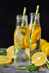 Summer drink - cold lemonade with mint on a concrete background