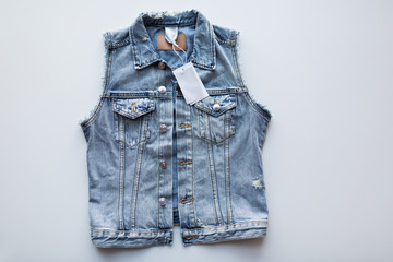 denim vest or waistcoat with price tag on white