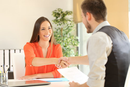 Employee and boss handshaking after a job interview