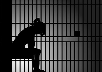 female behind prison bars - 135293578