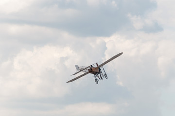 Fototapeta na wymiar Blériot XI Gnome engined production aircraft flies against cloudy sky background